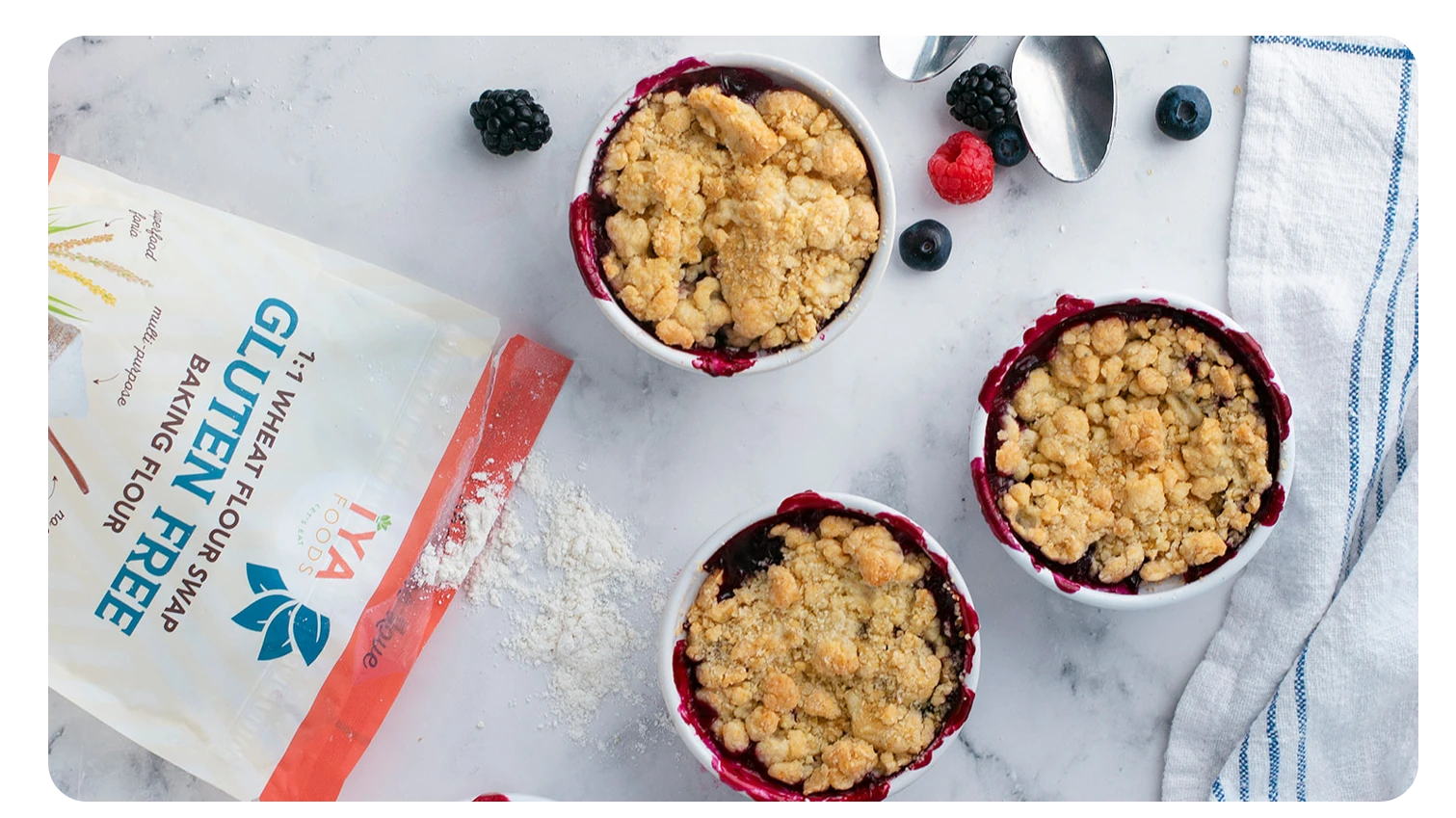 Three berry cobblers are displayed next to an open bag of gluten free flour