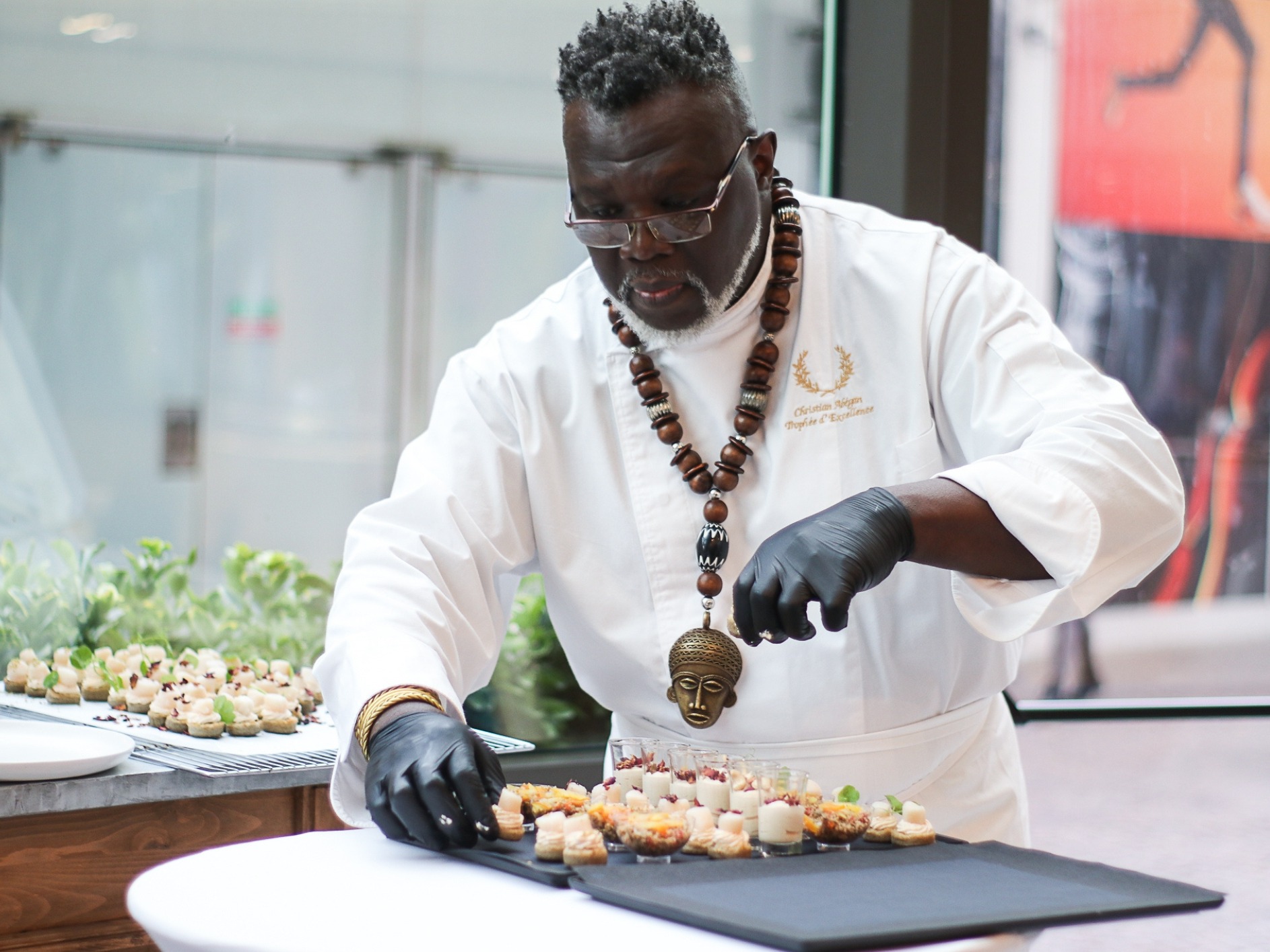 A chef puts the final touches on a plate of assorted desserts