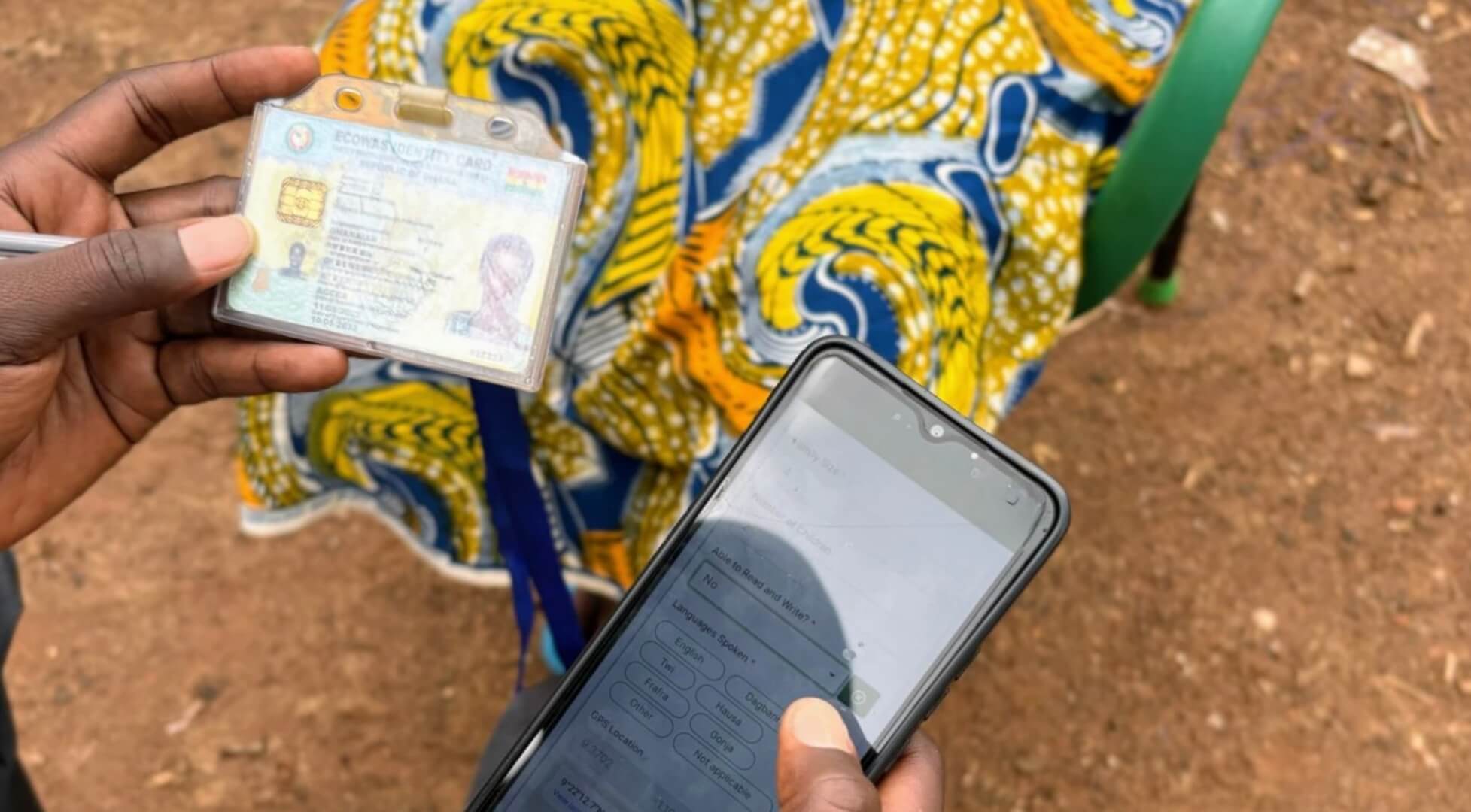 Someone is holding a phone next to an identification card